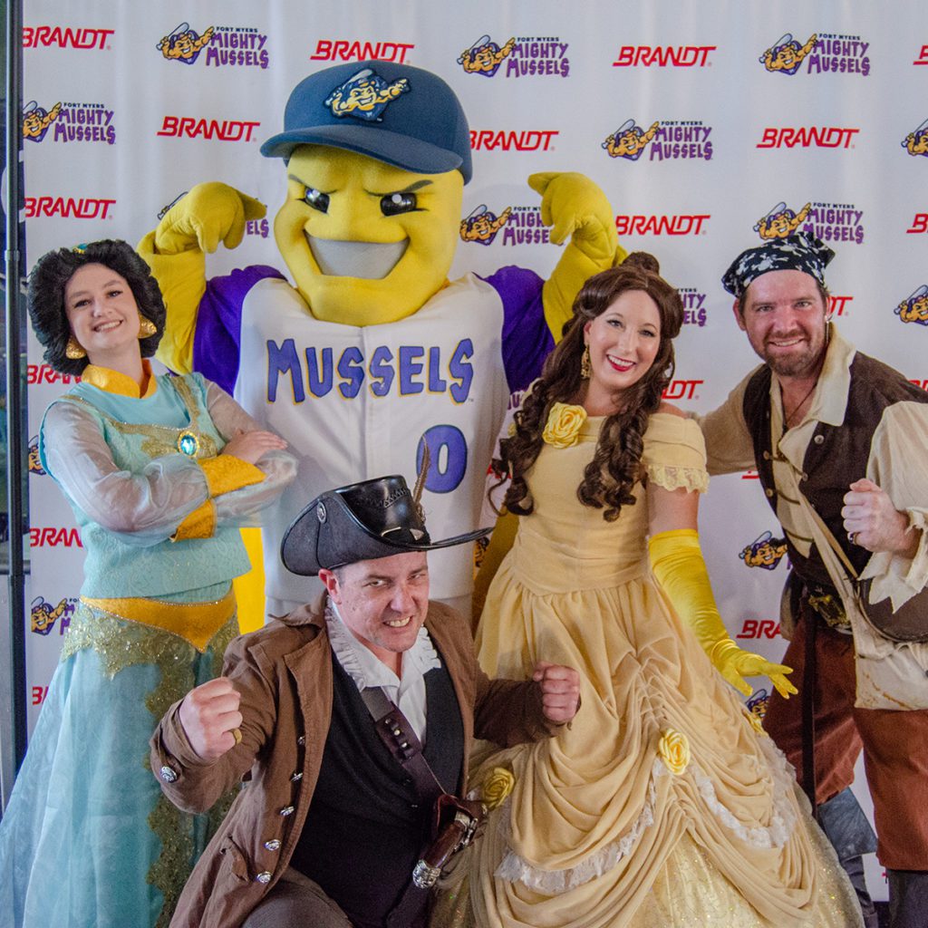 A photo of two pirates and two princesses posed with the Mighty Mussels mascot